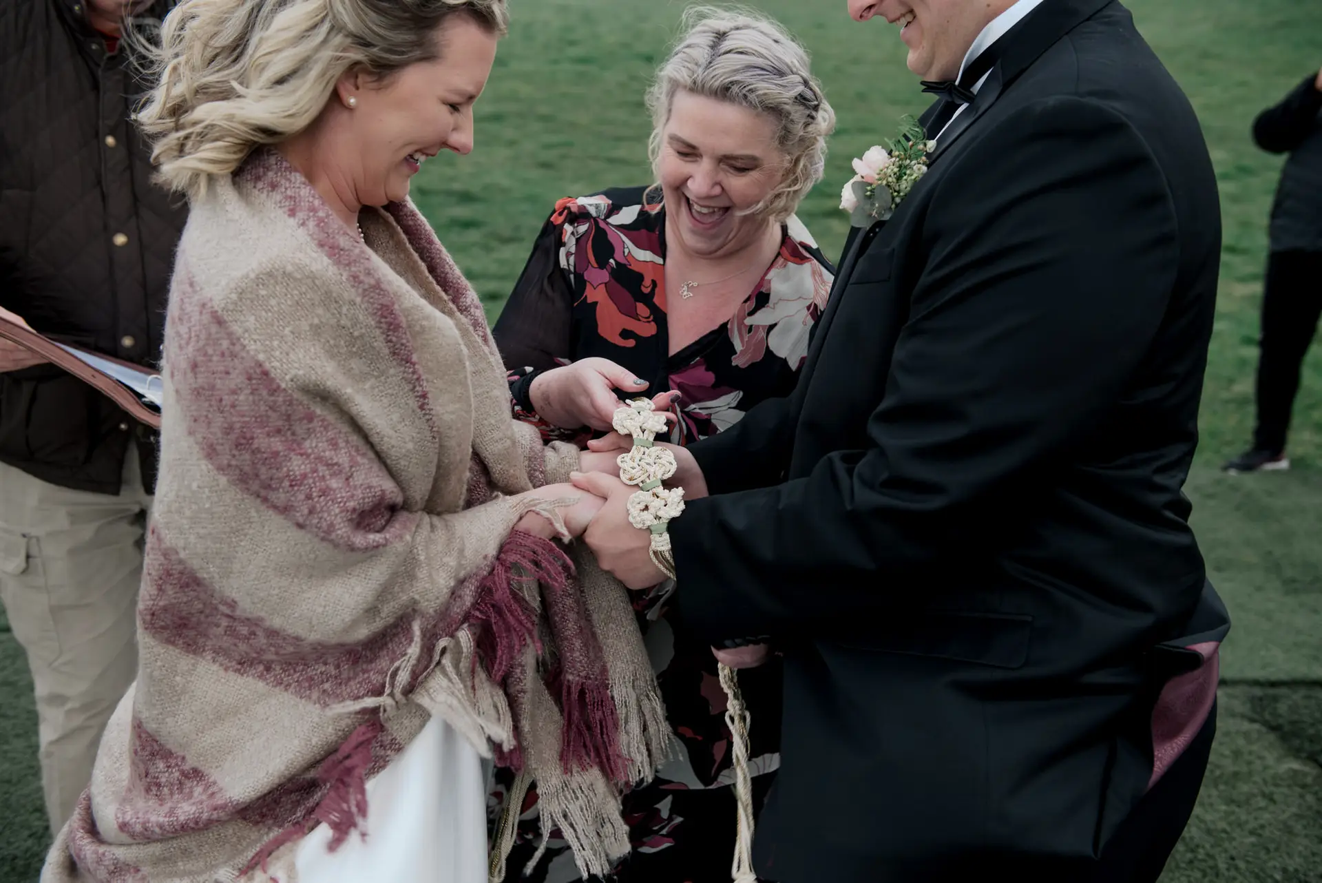 Caroline smiling with couple post-ceremony Celebrant Caroline with newlyweds after a non-religious wedding ceremony in Northern Ireland