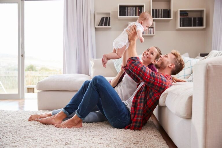 family playing with their adopted daughter after her naming ceremony to welcome her into the family
