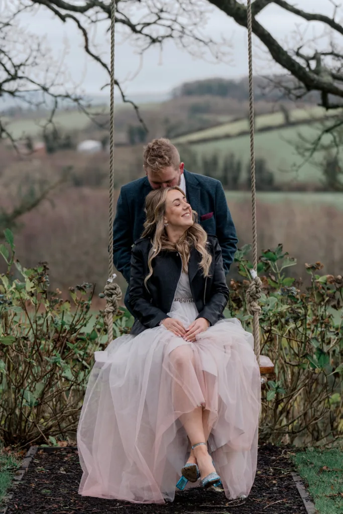couple on swing after their ceremony in ireland at tullyveery house