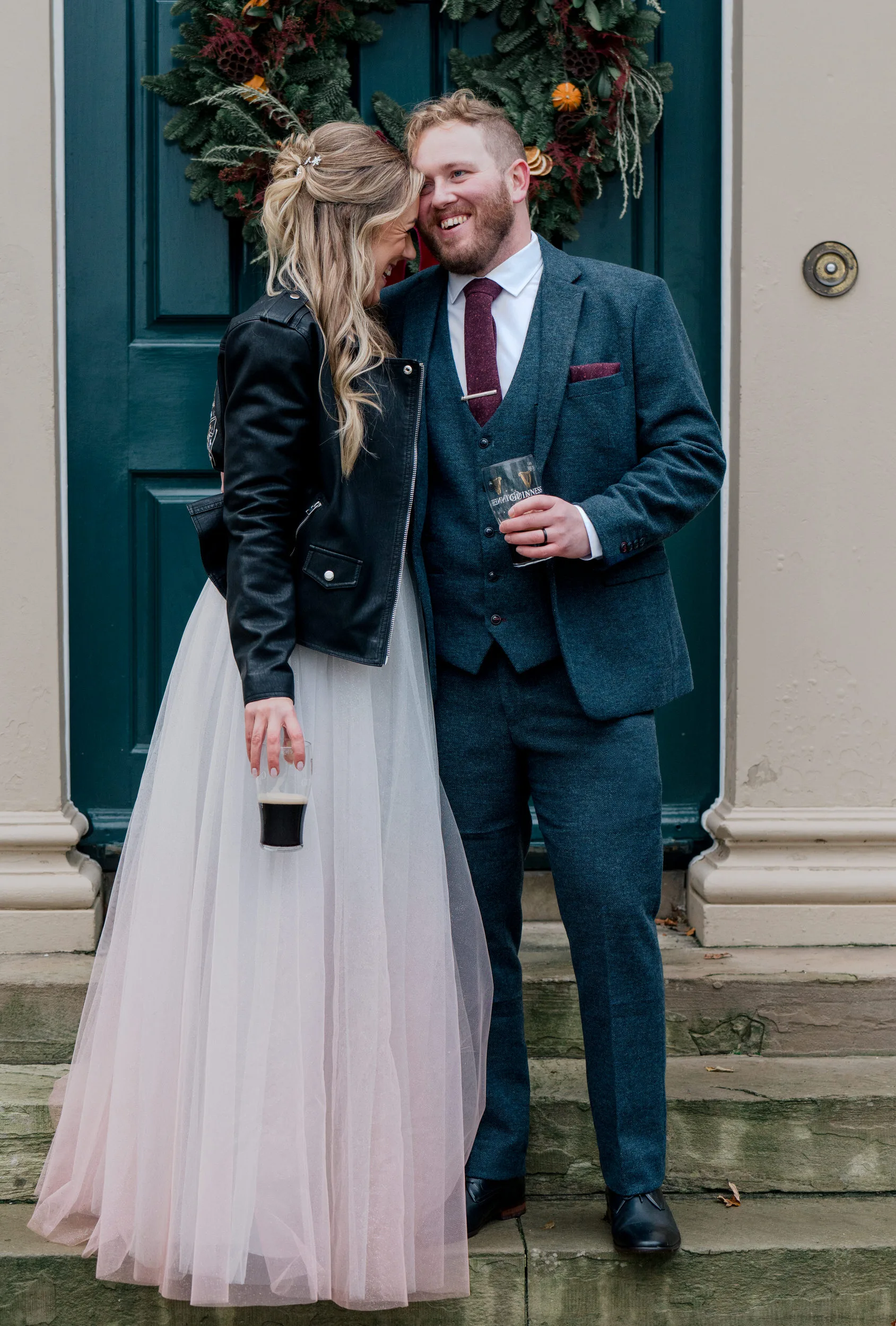 couple holding glasses of Guinness after their wedding at private venue Tullyveery house in Northern Ireland
